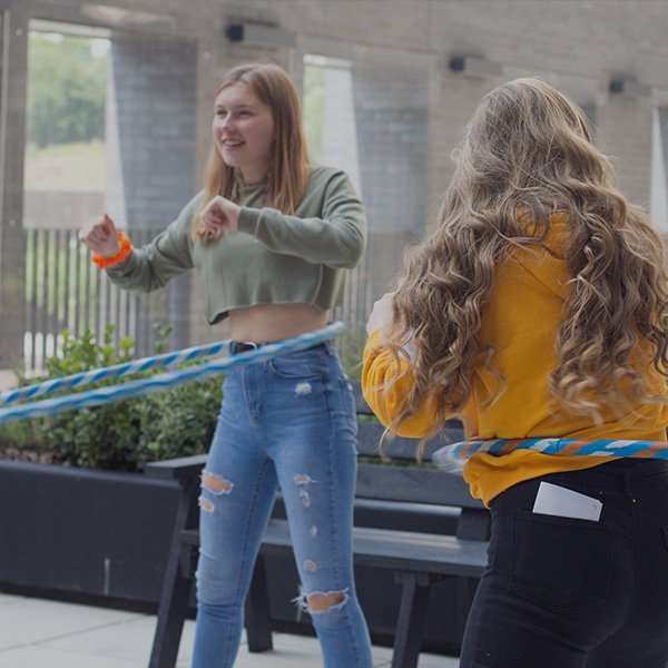 Young people playing with hoop