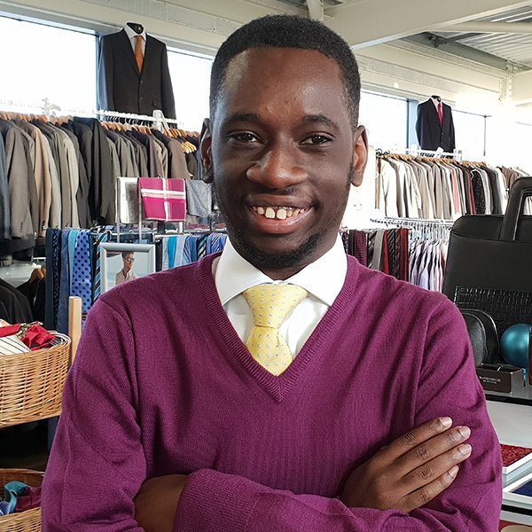 happy young person in suit shop