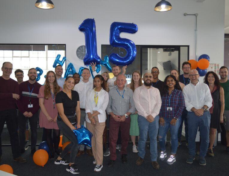 Picture of staff team with blue '15' balloons