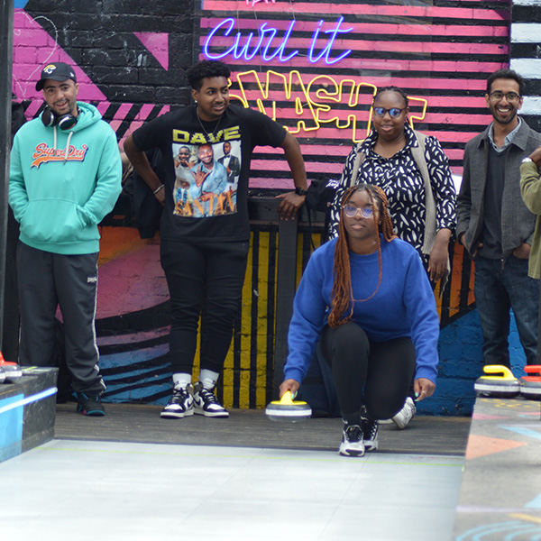 young people playing curling game at sport 4 life social event